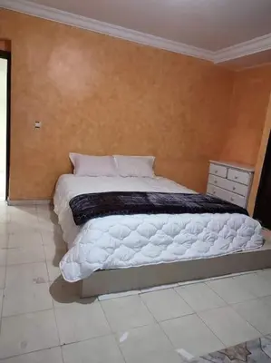 a bedroom with a large bed with white sheets at Escape! Ultimate Getaway for Friends in Casablanca