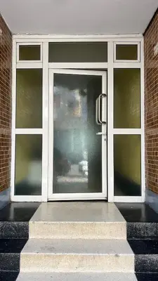 a large glass door with stairs in front of it at SUITOUISS - Océan 1 - Appartement centre ville au front de mer in Rabat
