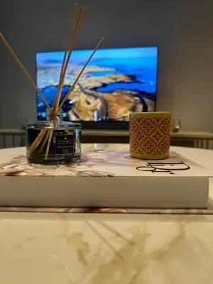 a table with a tv and a vase on it at Luxury Appt casa finance City CFC-Aeria Mall in Casablanca