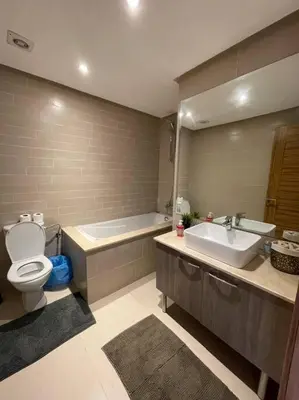 a bathroom with a tub and a toilet and a sink at Chic & cosy Flat Near Airport lockbox fast wifi in Nouaceur