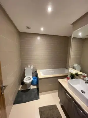 a bathroom with a toilet and a tub and a sink at Chic & cosy Flat Near Airport lockbox fast wifi in Nouaceur