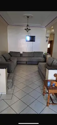 a living room with a couch and a tv at Mohamedia in Mohammedia
