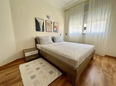a bedroom with a large bed and a window at Rabat, Appartement Neuf en face d'Arribat Center. in Rabat