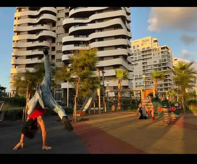 a person doing a handstand in the street in front of a building at Marina - Sea & Mosque View - By AppartAli in Casablanca