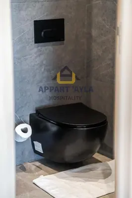 a bathroom with a black toilet in a room at Royal Ocean Suite - By Ayla Stay in Casablanca