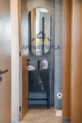 a bathroom with a sink and a mirror at Royal Ocean Suite - By Ayla Stay in Casablanca