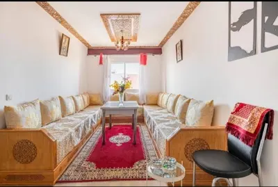 a living room with a couch and a table at Havre de Paix chez Lamine in El Harhoura
