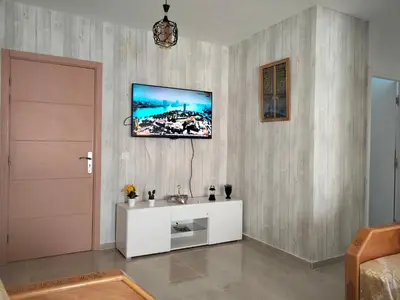 a living room with a sink and a tv on the wall at Havre de Paix chez Lamine in El Harhoura