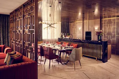 a dining room with a table and a bar at Royal Mansour Casablanca in Casablanca