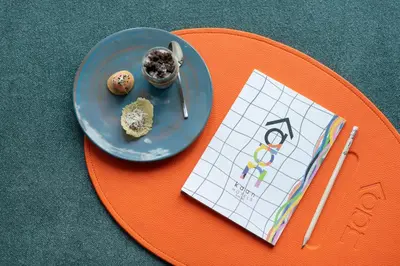 a table with a plate of food and a calendar at Kaan Casablanca in Casablanca