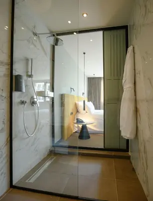 a bathroom with a shower with a glass door at JM Suites Hotel Eco-Friendly Casablanca in Casablanca