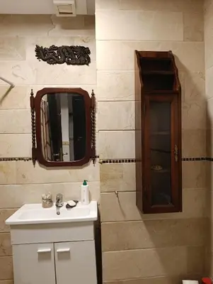 a bathroom with a sink and a mirror at Appartement de Charme Avec Vue Sur Mer in Casablanca