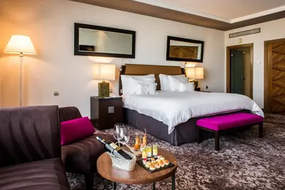 a hotel room with a bed and a couch at Kenzi Tower Hotel in Casablanca