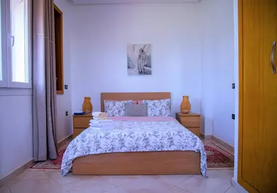 a bedroom with a large bed in a room at Instant Saisons - Ferme d'hôtes in Skhirat