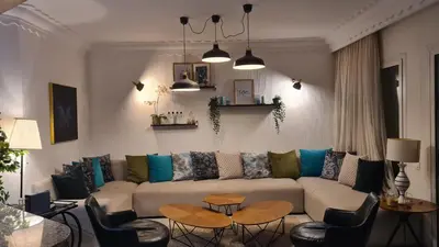 a living room with a couch and a table and chairs at Océan Beach in Tamaris