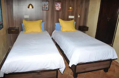 two beds with white and yellow pillows in a room at Gite Nadia in Casablanca