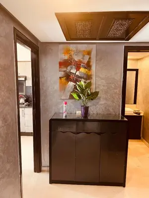 a kitchen with a black cabinet with a plant on it at Deluxe apartments in Casablanca