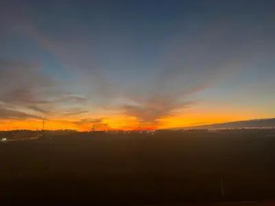 a sunset with a field in the foreground at Deluxe apartments in Casablanca