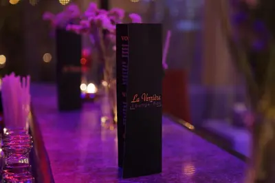 a black sign sitting on top of a table at Hotel Suisse in Casablanca