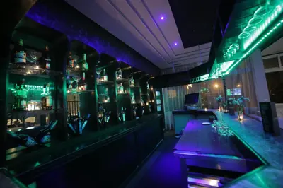 a bar with purple lights in a room at Hotel Suisse in Casablanca