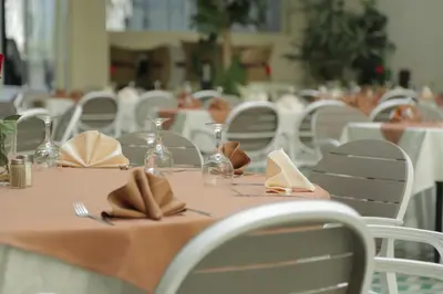 a table with napkins and glasses on top at Hotel Suisse in Casablanca