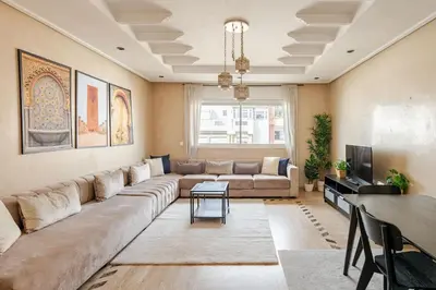 a living room with a large couch and a table at Arribat Center Mall- TT Holidays Agdal in Rabat