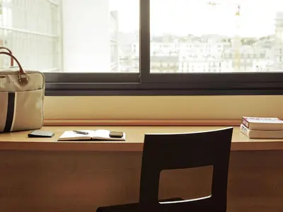 a chair sitting in front of a desk with a window at Ibis Casablanca Sidi Maarouf in Casablanca