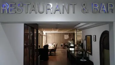 a sign for a restaurant and bar in a building at Hotel Toubkal in Casablanca