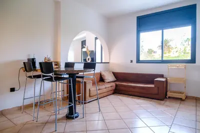a living room with a couch and a table at Sunset escape by the sea in Temara
