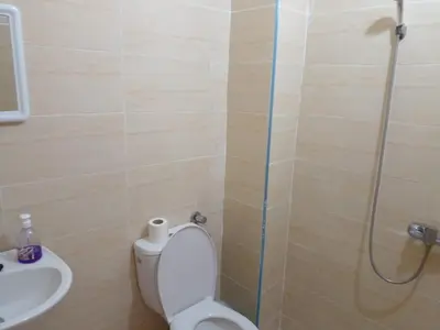 a bathroom with a toilet and a shower and a sink at Dar Ziyad Airport in Casablanca