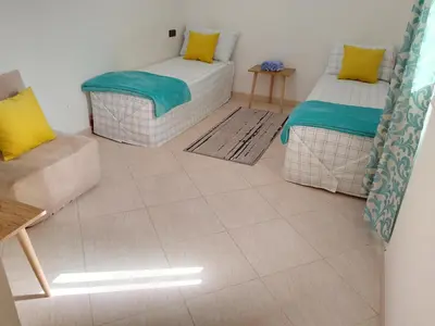 a living room with two beds and a couch at Dar Ziyad Airport in Casablanca