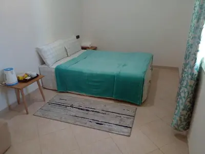 a bedroom with a bed and a couch and a table at Dar Ziyad Airport in Casablanca