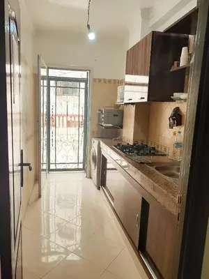 a kitchen with a sink and a stove at Appartement propre et bien équipé à Ain sebaa in Casablanca