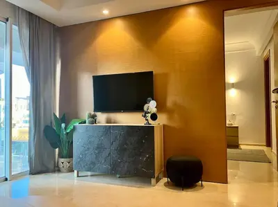 a living room with a flat screen tv on a wall at Casablanca Appartement haut standing CFC in Casablanca