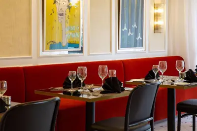 a dining room with two tables with wine glasses at Best Western Plus Casablanca City Center in Casablanca