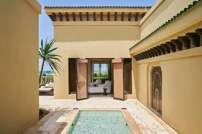 an exterior view of a house with a swimming pool at Mazagan Beach & Golf Resort in El Jadida