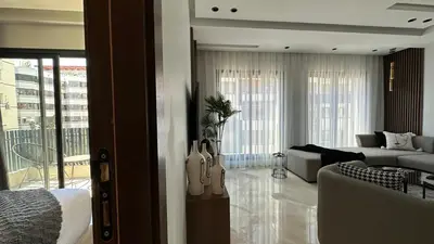 a bedroom with a living room with a couch and a living room with a couch at Charming and Central 2 Bedrooms - By AppartAli in Casablanca