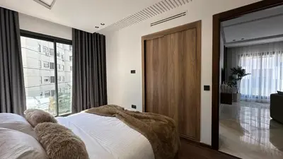 a bedroom with a bed and a large window at Charming and Central 2 Bedrooms - By AppartAli in Casablanca