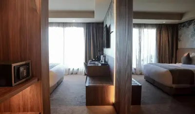 a hotel room with a bed and a television at Villa Blanca Urban Hotel in Casablanca