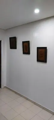 a white wall with three pictures on it at harmony house 2 in Rabat