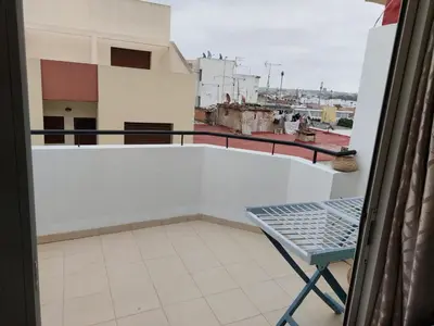 a balcony with a table and a view of a city at harmony house 2 in Rabat