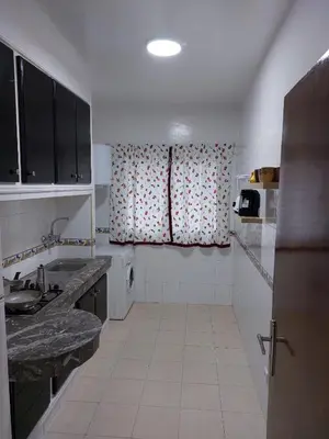 a small kitchen with a sink and a window at harmony house 2 in Rabat