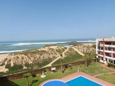 a view of a hotel and the beach with a pool at appartement au bord de l'eau in Mohammedia