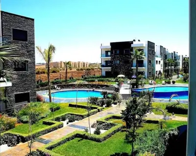 a view of a resort with two swimming pools at Garden Bay - Appartement en bord de mer in Tamaris