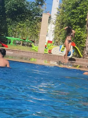 a girl in a bikini playing in a swimming pool at HEAVEN BEACH in Sidi Rahal